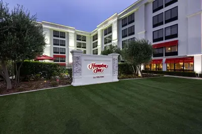 a sign in front of a large building at Hampton Inn by Hilton San Diego - Kearny Mesa in San Diego