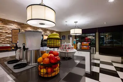 a kitchen with fruit in baskets on a counter at Hampton Inn by Hilton San Diego - Kearny Mesa in San Diego