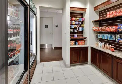 a grocery store aisle with a refrigerator and a aislengthngthngthngth at Homewood Suites by Hilton San Diego-Del Mar in San Diego