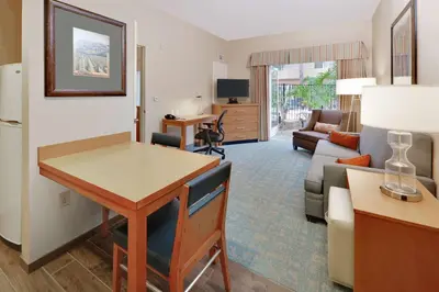a living room with a table and a couch at Homewood Suites by Hilton San Diego-Del Mar in San Diego