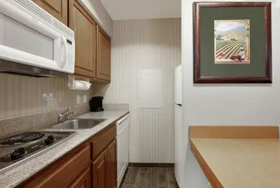 a small kitchen with a sink and a microwave at Homewood Suites by Hilton San Diego-Del Mar in San Diego