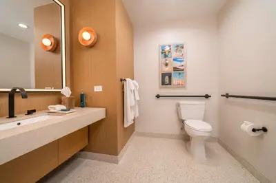 a bathroom with a toilet and a sink and a mirror at Hilton San Diego Gaslamp Quarter in San Diego