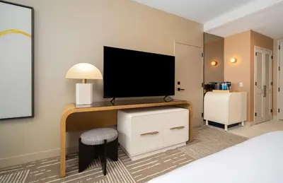 a room with a bed and a television on a desk at Hilton San Diego Gaslamp Quarter in San Diego