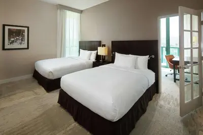 a hotel room with two beds and a desk at DoubleTree By Hilton San Diego Hotel Circle in San Diego
