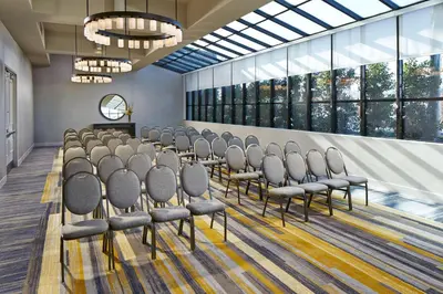 a row of chairs in a room with windows at Hilton San Diego Mission Valley in San Diego