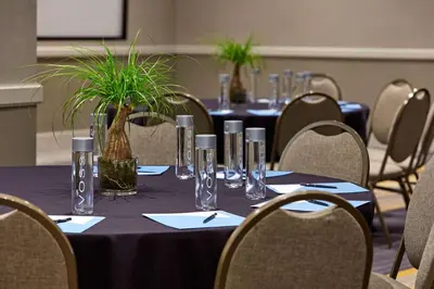 a table with glasses and plants on top of it at Hilton San Diego Mission Valley in San Diego