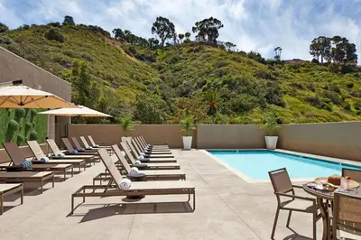 a row of lounge chairs and a swimming pool at Hilton San Diego Mission Valley in San Diego