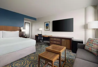 a hotel room with a bed and a desk and a tv at DoubleTree by Hilton San Diego Del Mar in San Diego