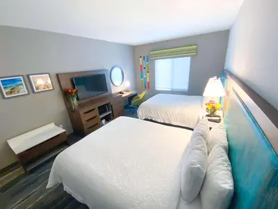 a hotel room with two beds and a television at Hampton Inn Carlsbad North San Diego County in Carlsbad