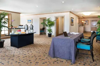 a hotel lobby with a table with a laptop on it at Hilton San Diego Airport/Harbor Island in San Diego