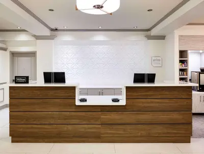 a kitchen with a counter with two monitors on it at Hilton Garden Inn San Diego/Rancho Bernardo in Rancho Bernardo