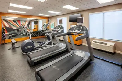 a gym with several treadmills and a large screen at Hilton Garden Inn San Diego/Rancho Bernardo in Rancho Bernardo