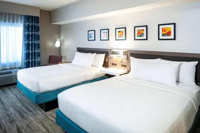 a hotel room with two beds and a desk at Hilton Garden Inn San Diego/Rancho Bernardo in Rancho Bernardo