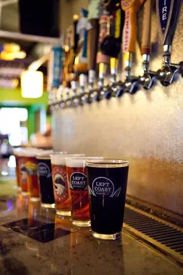 a group of glasses of beer sitting on a bar at Nomads Hotel in San Clemente
