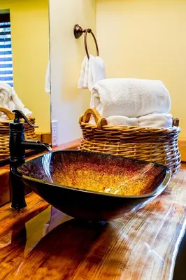 a bathroom with a bath tub on a wooden floor at Nomads Hotel in San Clemente