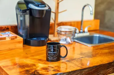a black coffee mug sitting on a kitchen counter at Nomads Hotel in San Clemente