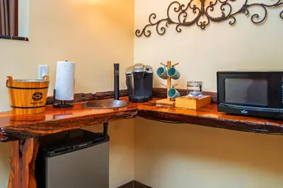 a wooden counter top with a television and a microwave at Nomads Hotel in San Clemente