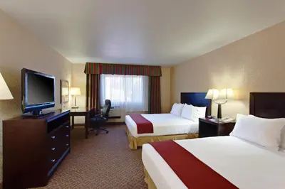 a hotel room with two beds and a flat screen tv at Holiday Inn Express Temecula by IHG in Temecula