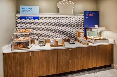 a bakery with a counter with donuts on it at Holiday Inn Express Temecula by IHG in Temecula