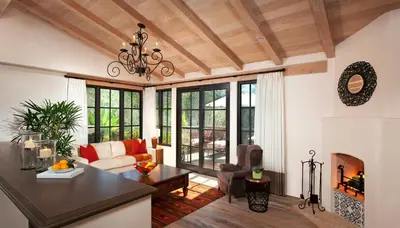 a living room with a chandelier and a fireplace at Rancho Valencia Resort and Spa in Rancho Santa Fe