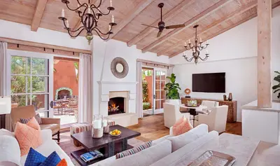 a living room with white furniture and a fireplace at Rancho Valencia Resort and Spa in Rancho Santa Fe