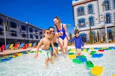 a family playing in the water at a swimming pool at LEGOLAND California Hotel and Castle Hotel in Carlsbad