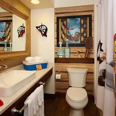 a bathroom with a toilet and a sink and a mirror at LEGOLAND California Hotel and Castle Hotel in Carlsbad