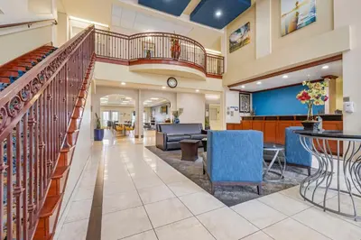 a lobby of a hospital with a staircase and a waiting room at Best Western Plus Lake Elsinore Inn & Suites in Lake Elsinore