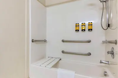 a bathroom with a tub and a shower stall at Best Western Plus Lake Elsinore Inn & Suites in Lake Elsinore
