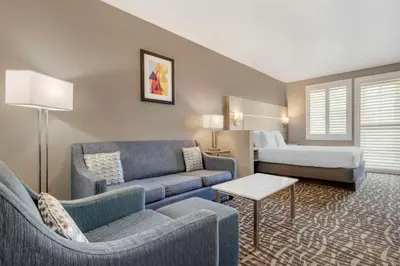 a hotel room with a couch and a bed at Best Western Plus Lake Elsinore Inn & Suites in Lake Elsinore