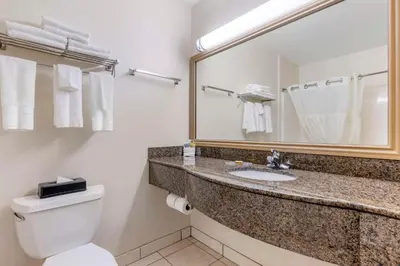 a bathroom with a sink and a toilet and a mirror at Best Western Plus Lake Elsinore Inn & Suites in Lake Elsinore
