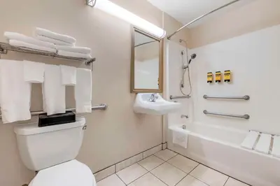 a bathroom with a toilet and a sink and a tub at Best Western Plus Lake Elsinore Inn & Suites in Lake Elsinore