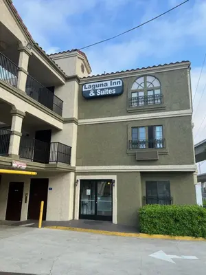 a building with a sign that reads edmonton inn and suites at Laguna Inn and Suites in San Juan Capistrano