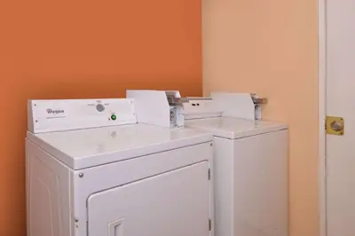 two washing machines sitting next to each other in a room at Laguna Inn and Suites in San Juan Capistrano