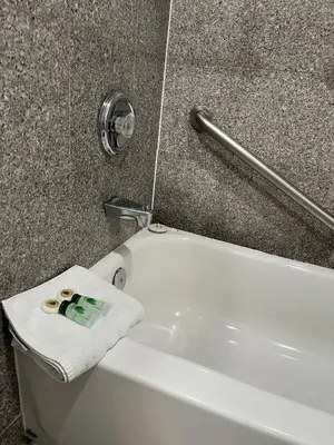 a white bath tub with a towel on top of it at Laguna Inn and Suites in San Juan Capistrano