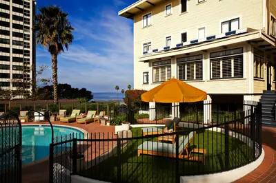 a house with a pool in front of a building at Grande Colonial La Jolla in San Diego
