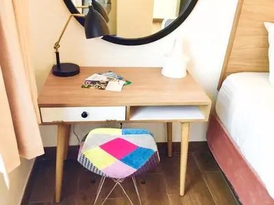 a desk in a bedroom with a bed and a mirror at Downtown San Diego Lodge in San Diego