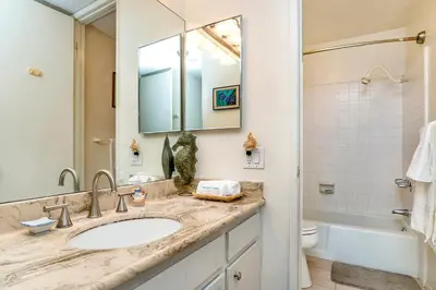 a bathroom with a sink and a toilet and a mirror at Condo in Beachfront Resort B-212 in Oceanside