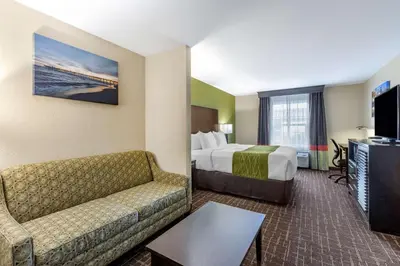 a hotel room with a bed and a couch and a tv at Comfort Inn San Diego Old Town in San Diego