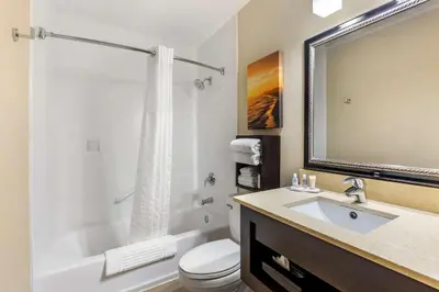 a bathroom with a tub and a toilet and a sink at Comfort Inn San Diego Old Town in San Diego