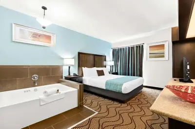 a hotel room with a bed and a bath tub at Best Western Plus Irvine Spectrum Hotel in Lake Forest