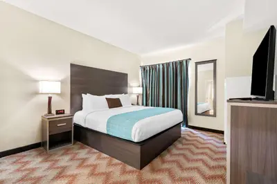a hotel room with a bed and a flat screen tv at Best Western Plus Irvine Spectrum Hotel in Lake Forest