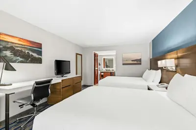a hotel room with two beds and a desk at Best Western Chula Vista/Otay Valley Hotel in Chula Vista
