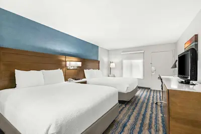 a hotel room with two beds and a flat screen tv at Best Western Chula Vista/Otay Valley Hotel in Chula Vista