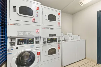a laundry room with four washer and dryers at Best Western Chula Vista/Otay Valley Hotel in Chula Vista
