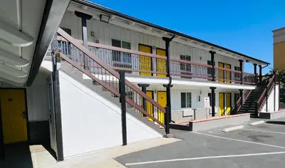 a building with a staircase in a parking lot at Escondido Inn in Escondido