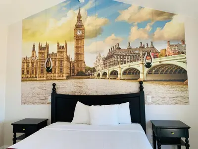 a bedroom with a large picture of big ben and big benramid at Escondido Inn in Escondido