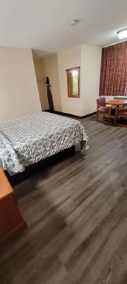 a hotel room with a bed and a table at Harvey's Motel SDSU La Mesa San Diego in San Diego