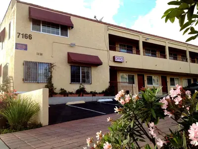 a building with a parking lot in front of it at Harvey's Motel SDSU La Mesa San Diego in San Diego