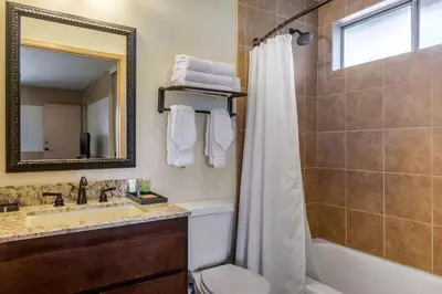 a bathroom with a tub and a sink and a shower at Carlton Oaks Lodge, an Ascend Collection Hotel in Santee